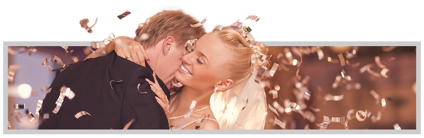 Groom snuggling neck of bride during slow dance with confetti